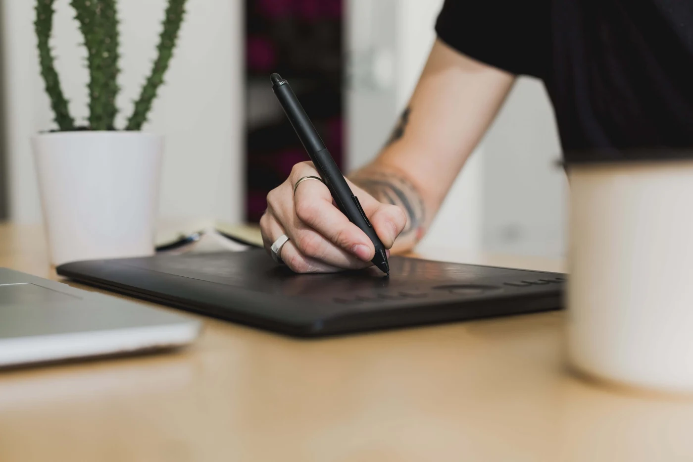 A interaction designer working at an office desk with a Macbook