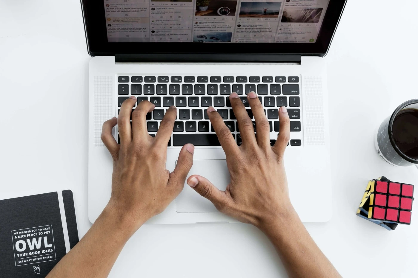 A interaction designer working at an office desk with a Macbook