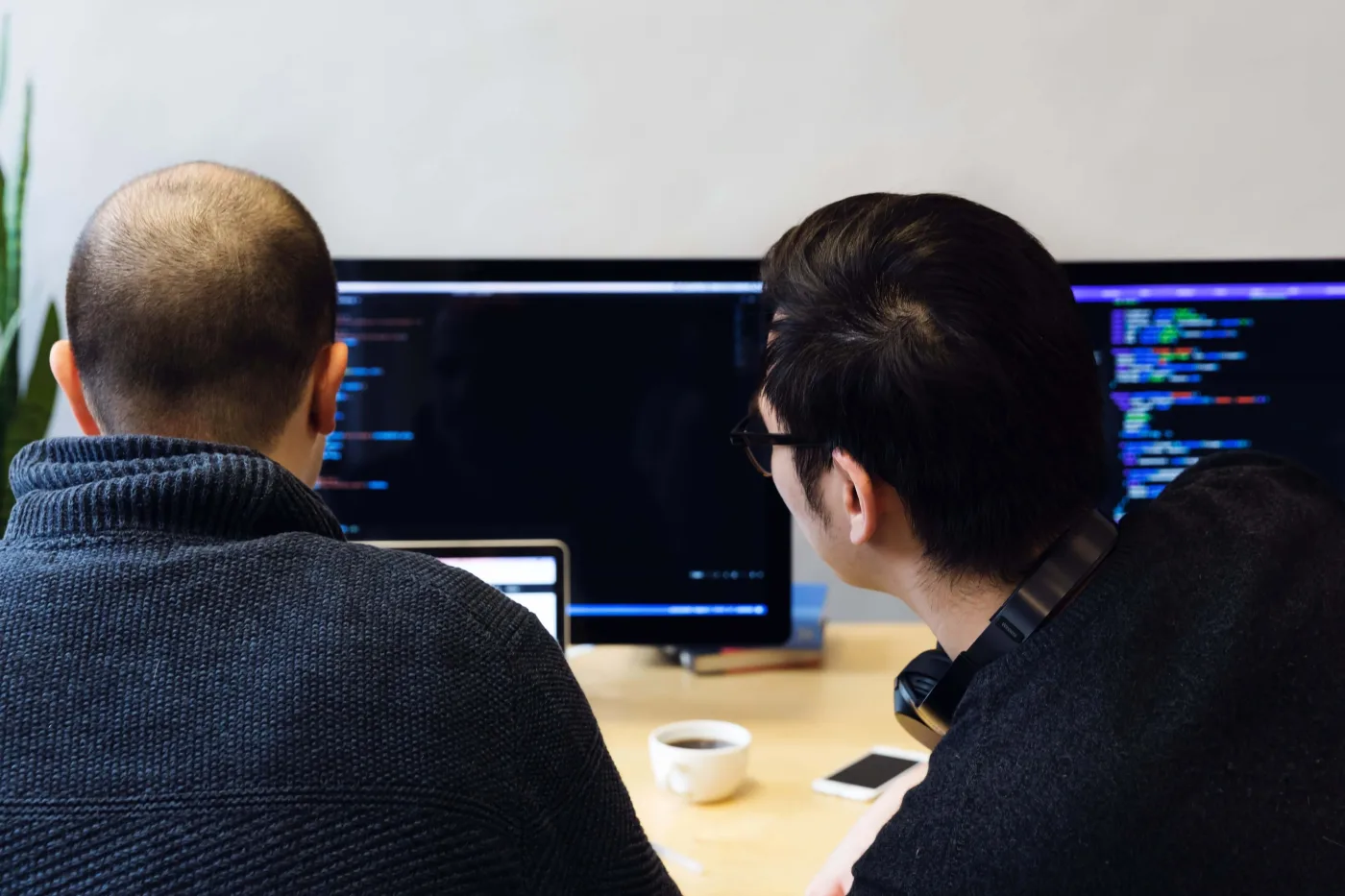 Two software engineers working at a desk